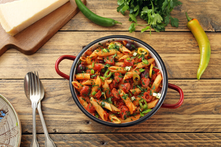 Italian,pasta,with,sausages,in,sauce,tomato,rustic,table,background