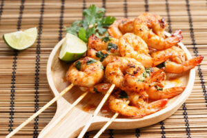 Shrimp,sriracha,kebabs,with,lime,and,cilantro,leaves